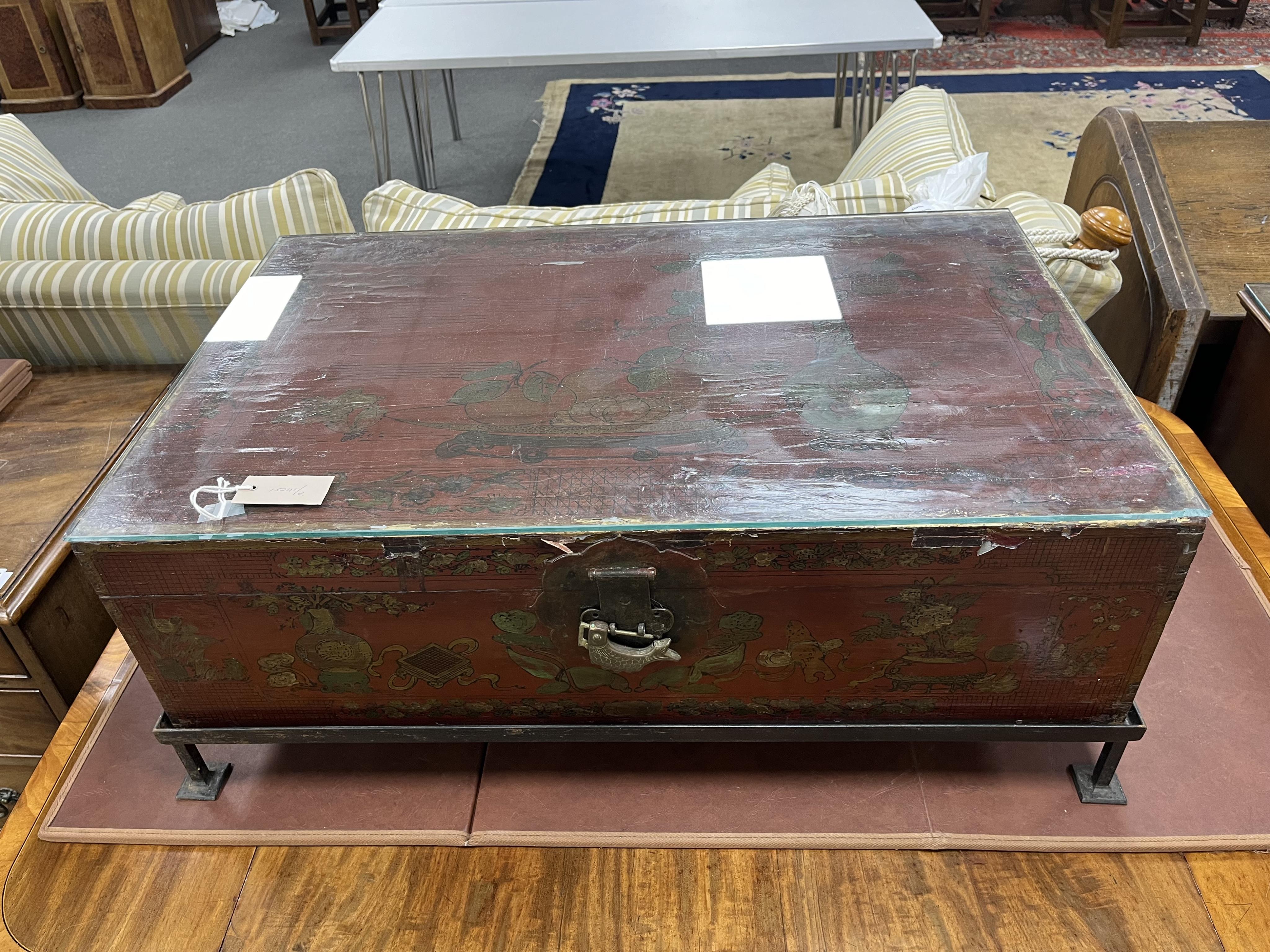 A Chinese lacquer trunk, on an associated metal stand, width 84cm, depth 53cm, height 31cm. Condition - poor